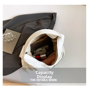 Interior view showing the large capacity of a white tote bag with daily essentials