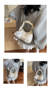 Detail of off-white pleated dumpling bag with silver chain and cute cloud pendant