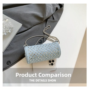 Close-up of light blue studded barrel bag with silver chain strap and phone for size