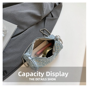 Interior view of blue rhinestone cylinder bag showing capacity for cosmetics and lipstick