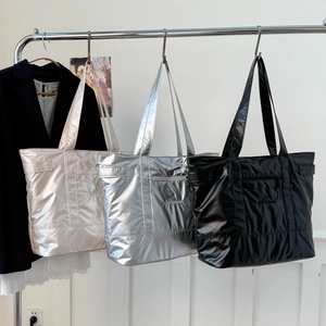 Large glossy tote bag in white, silver, and black with embroidery and front zipper