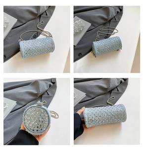 Detailed macro view of light blue cylindrical rivet bag with stylish gold studs and chain strap