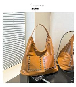 Detail of brown PU leather tote bag with silver hexagonal rivets on front pockets
