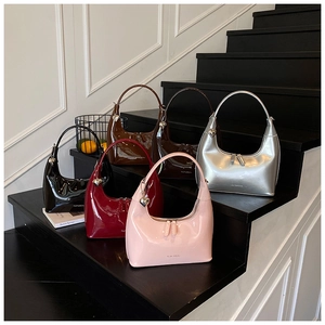 Hobo crescent bags in six glossy patent leather colors with heart charms on stairs