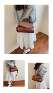Detailed view of brown leather bag with geometric fold structure and stitching