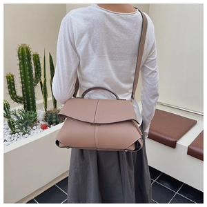 Morandi pink handbag with geometric fold design and pebble leather texture detail