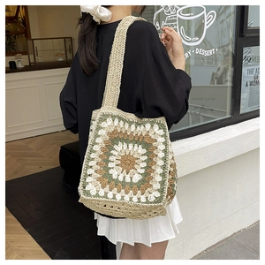 Close-up of handmade crochet tote bag with colorful floral granny square patterns