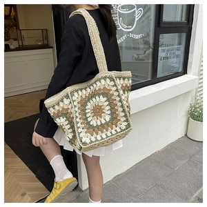 Close-up of handmade crochet tote bag featuring olive green sunflower granny square patterns