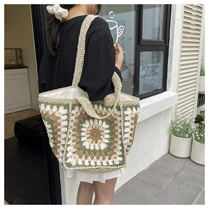 Detailed close-up of bohemian crochet tote bag featuring vintage mandala floral patterns
