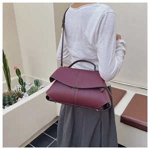 Burgundy litchi grain handbag with white contrast stitching shown from a back view