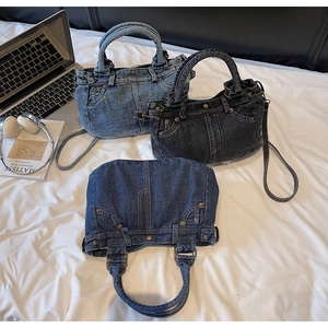 Dettaglio della borsa di jeans vintage con rivetti, cuciture e tracolle regolabili