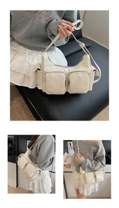 Detail of beige glossy shoulder bag showing multiple utility pockets and zip texture