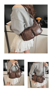 Close-up of retro dark brown glossy patent leather shoulder bag with multi-pocket details