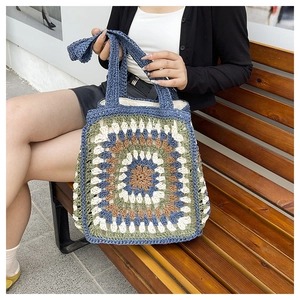 Detail of colorful granny square crochet tote bag featuring bohemian knitted patterns