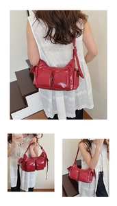 Detail of red patent leather shoulder bag featuring multiple functional front pockets