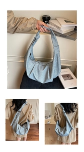 Close-up of blue pleated dumpling bag featuring knotted shoulder strap and textured fabric