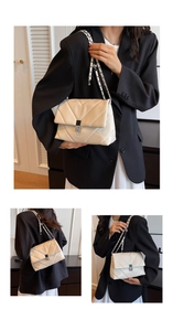 Detailed view of beige quilted faux leather bag with V-pattern stitching and silver lock