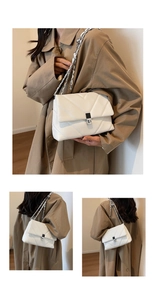 Detailed close-up of a white quilted crossbody bag with a silver square metal buckle