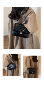 Detail of silver clasp and V-shaped quilted texture on black faux leather shoulder bag