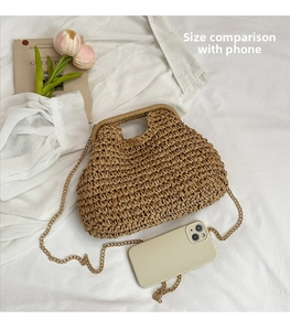 Detail view of woven straw bag with metal chain strap and smartphone size comparison