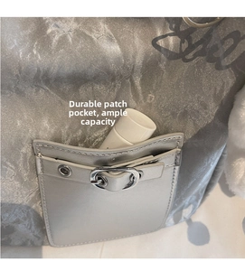 Detail view of durable front pocket on silver metallic bag showing storage capacity