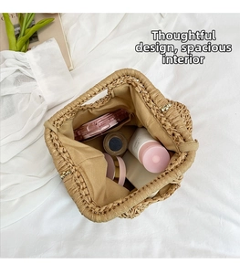 Internal view of woven straw tote showing beige fabric lining and spacious storage