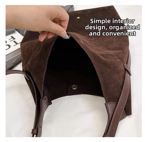 Close-up of spacious interior and magnetic closure of the brown suede tote bucket bag