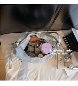 Interior view of spacious silver tote bag showing compartments and daily essentials storage