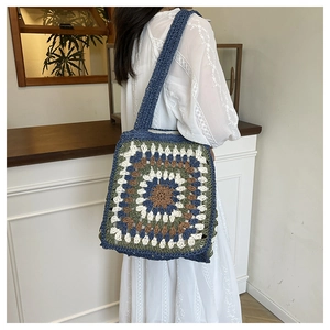Bohemian crochet tote bag detail featuring colorful granny square patterns and woven strap