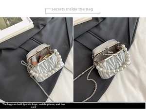 Detail of silver quilted mini bag interior with pearl strap and metal chain