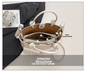 Top view of the inner structure of a creamy crocodile texture bucket bag with pockets