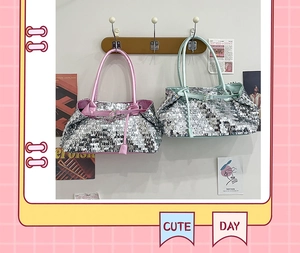 Close-up of sparkling sequin tote bag featuring pink faux leather handles and trendy textures