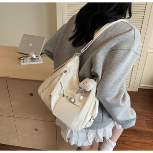 Detail of off-white PU leather hobo bag with cloud charm and silver metallic zipper
