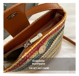 Detail shot of the metal magnetic buckle and zipper on the rainbow straw bucket bag