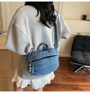 Blue denim crossbody bag worn by model, showing casual style and spacious design
