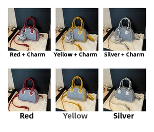 Detail view of denim Boston bags in red, yellow and silver with star pendant decor