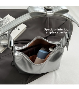 Top view of the spacious interior of a silver metallic hobo bag with zip closure