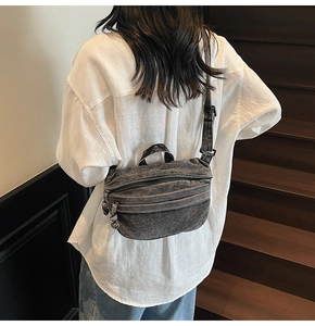 Detailed view of gray washed canvas crossbody bag with adjustable strap and pockets