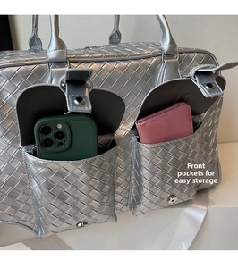 Detail view of woven travel bag front pockets showing storage for phone and wallet