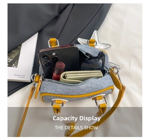 Spacious interior of blue denim mini Boston bag showing phone, wallet and sunglasses