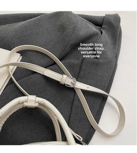 Detail view of cream bowling bag showing padded handle and adjustable shoulder strap