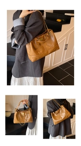 Detail of a brown quilted leather tote bag with gold chain strap and metal turn-lock