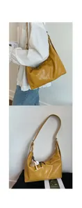 Detail of a large ginger yellow tote bag with textured faux leather and bear charm