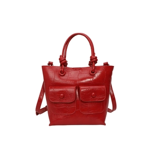 Red crocodile pattern handbag with dual top handles and adjustable shoulder strap