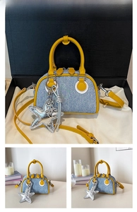 Detail of yellow leather handle on denim tote bag with silver glitter star charm
