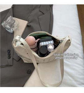 Interior view showing the large capacity of the beige studded shoulder bag for essentials