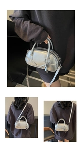 Detailed macro of silver metallic texture bowling bag with retro zipper and charm