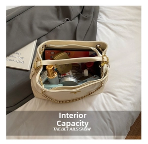 Spacious interior of a quilted tote bag showing storage for tablet and cosmetics