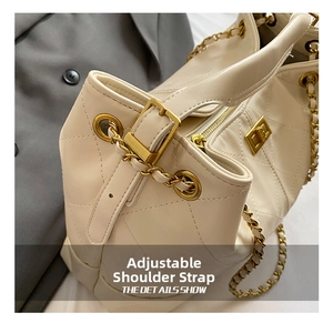 Detail of quilted diamond pattern bag with gold chain strap and adjustable buckle