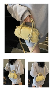 Detail of yellow mini bowling bag featuring top handles and detachable shoulder strap